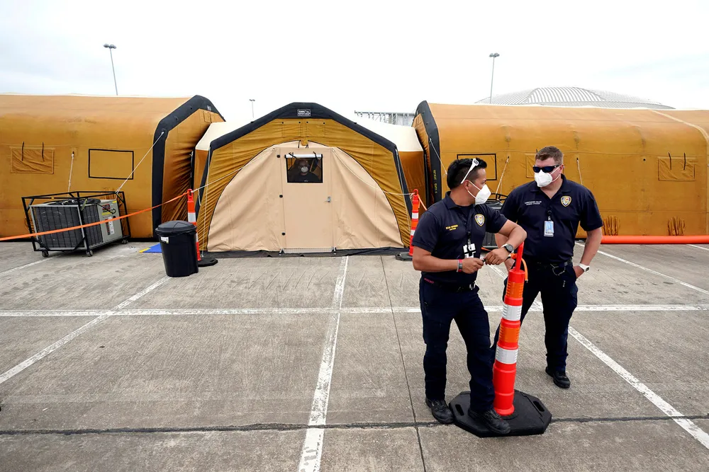 Standing by: members of the Houston Fire Department outside a temporary hospital set up last month at NRG Park, where the Offshore Technology Conference is normally held. This year's event was cancelled because of the Covid-19 emergency.