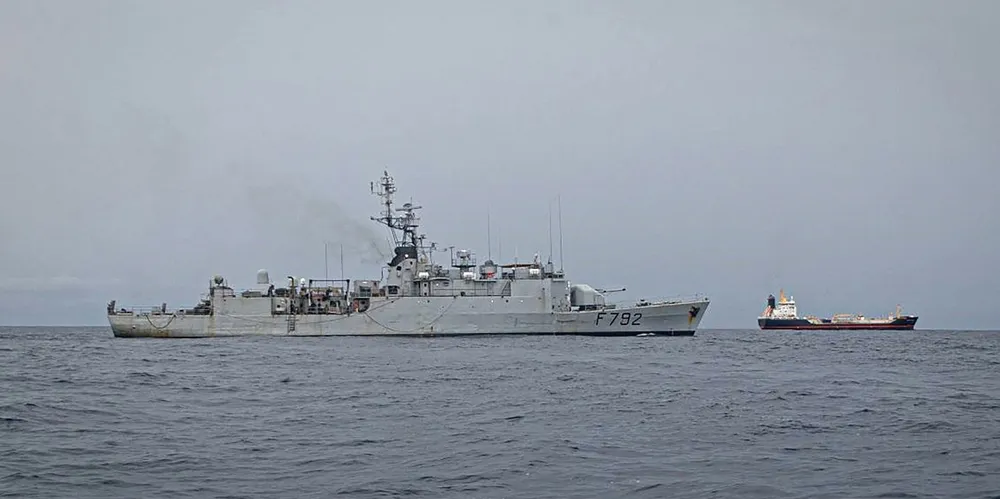 A warship accompanies the product tanker Monjasa Reformer after it was hijacked in the Gulf of Guinea in March. Six of the ship's crew were kidnapped.