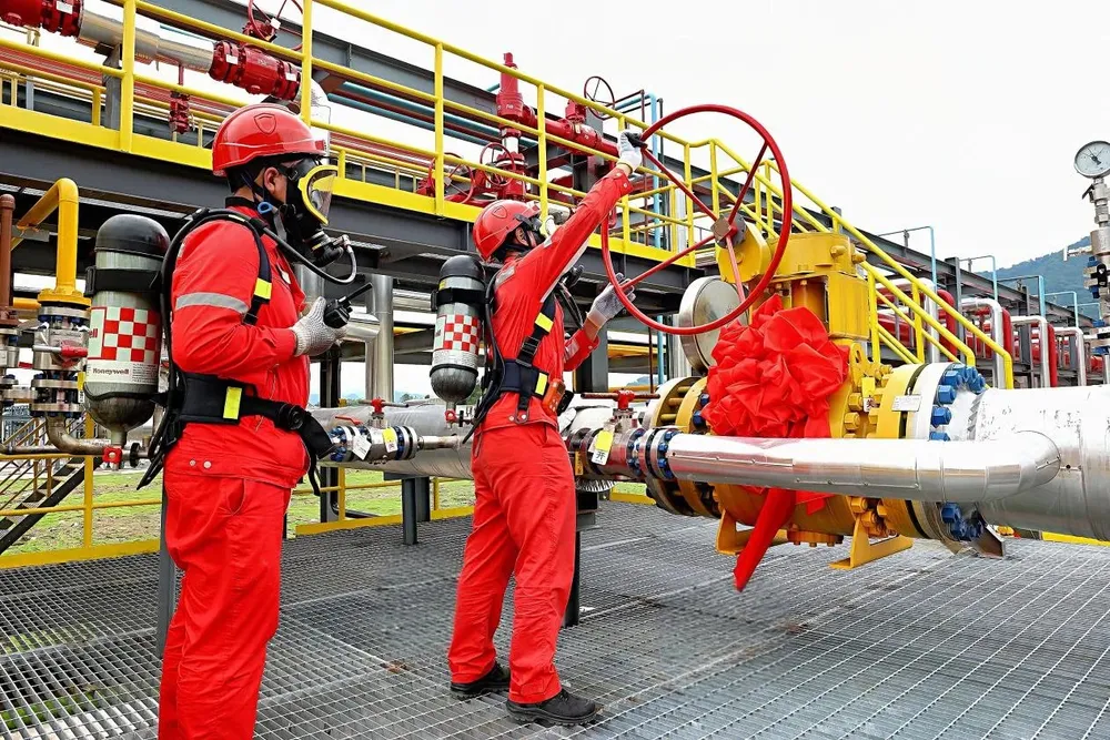 Workers turn on the tap at the PetroChina-operated Dukouhe-Qilibei sour gas field.