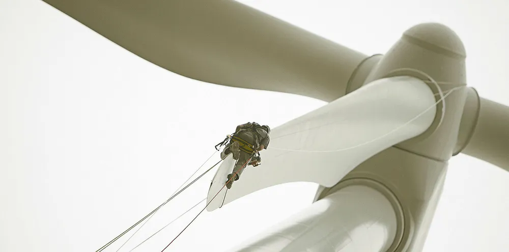 LM Wind Power service technician on blade tip at Brena wind farm, Spain