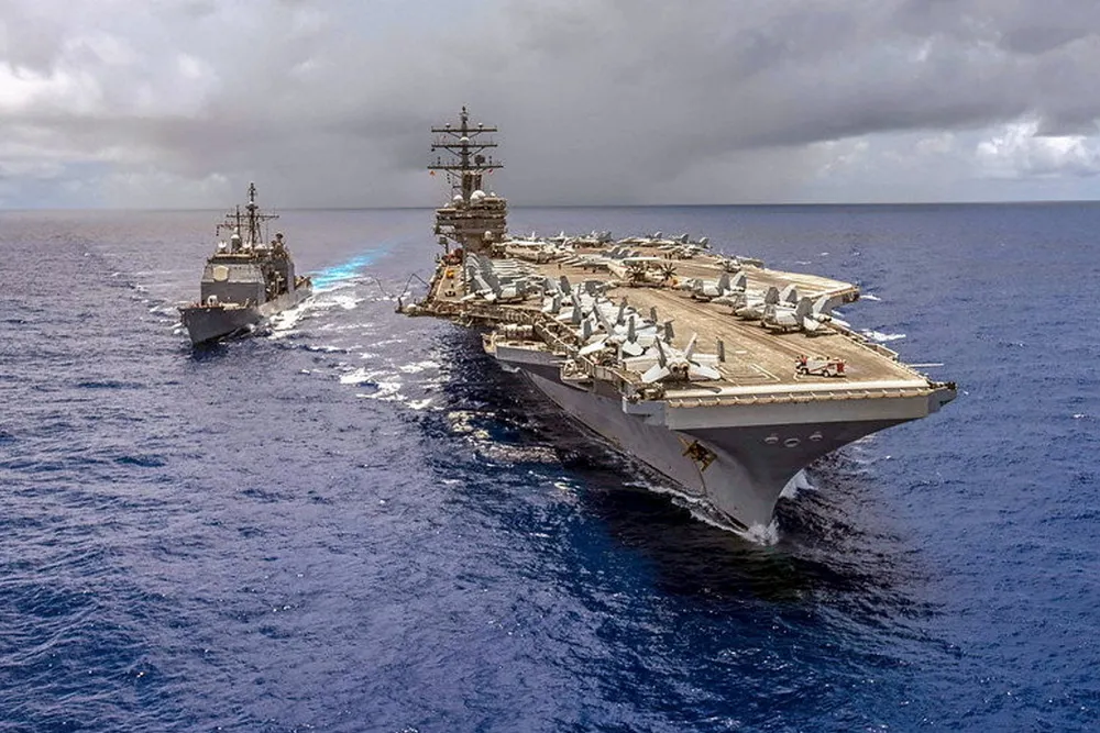 The guided-missile cruiser USS Antietam alongside the Navy's forward-deployed aircraft carrier USS Ronald Reagan.