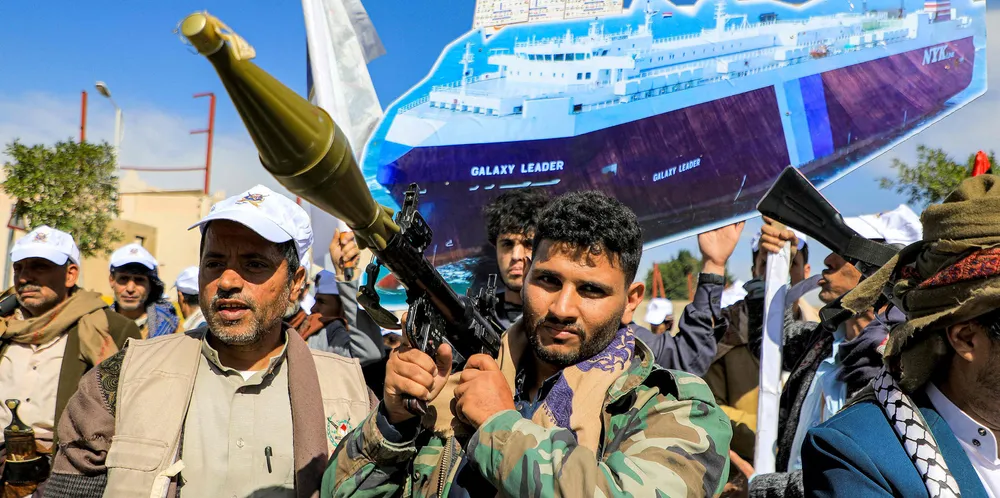 A sign depicting the car carrier Galaxy Leader, which was seized by fighters of Yemen’s Houthi movement in late 2023, is held by a protester behind a man carrying a rocket-propelled grenade launcher during a pro-Palestinian rally in the Houthi-held capital Sanaa on 7 February.