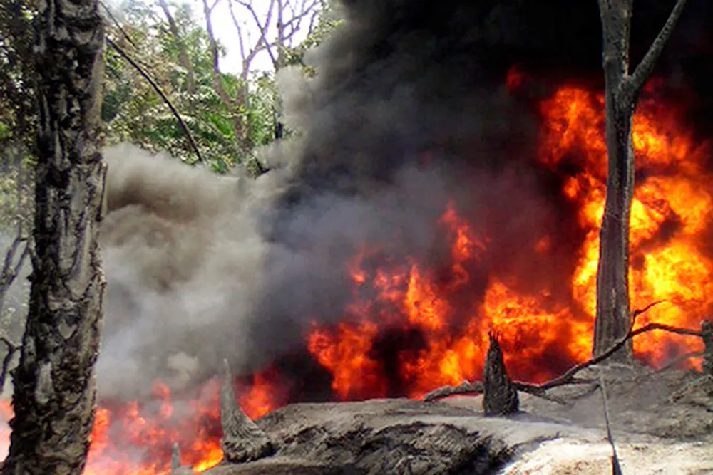 Devastated: an oil pipeline fire burns near the village of Goi in Nigeria