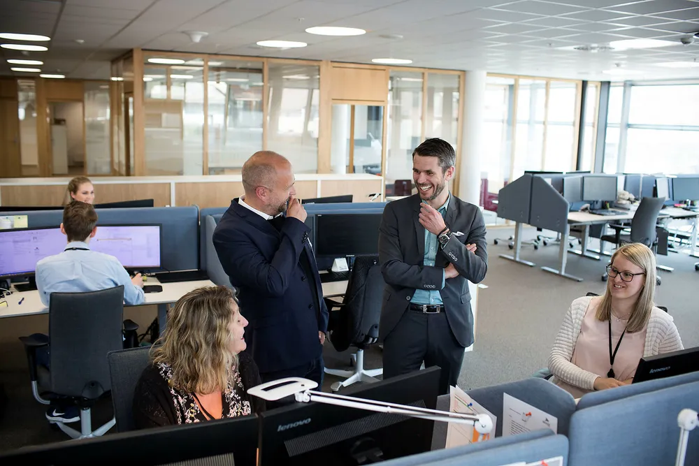 Jan Åge Skaathun (bak til venstre) i Quantfolio og Henrik Lie-Nielsen i Stacc lager kjernesystemer til bank- og finansbransjen. Blant annet har de levert arbeidsverktøyet til Siril Steine (til høyre) og Linda K. Køster i Brage Finans, eid av Sparebanken Vest. Foto: Silje Katrine Robinson
