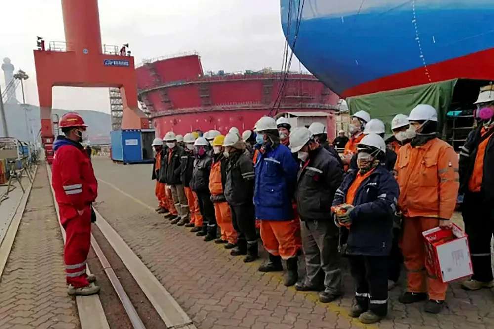 Ready to board: Workers receive precautionary tips for avoiding Covid-19 before starting their shift on Shell's Penguin FPSO at COOEC Qingdao yard