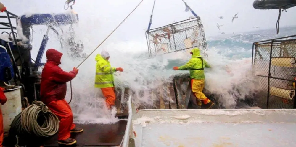 Alaska crab fishermen haul in a pot in rough waters.