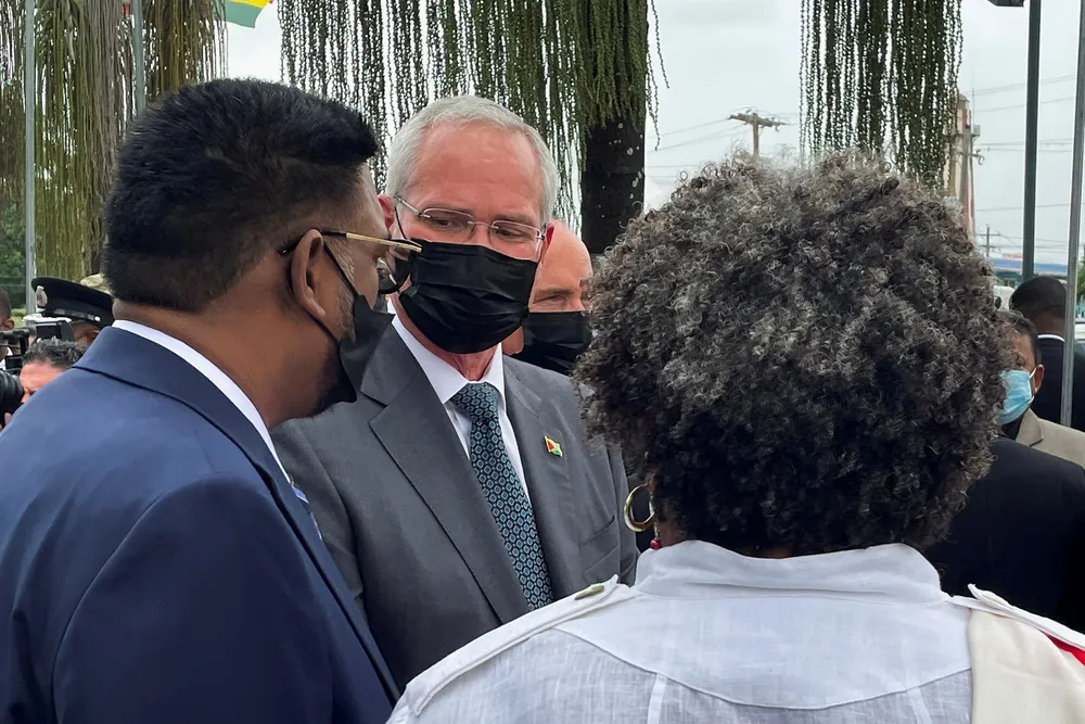 Guyana’s president Irfaan Ali speaks to Exxon Mobil chief executive Darren Woods during Guyana’s International Energy Conference in Georgetown, Guyana