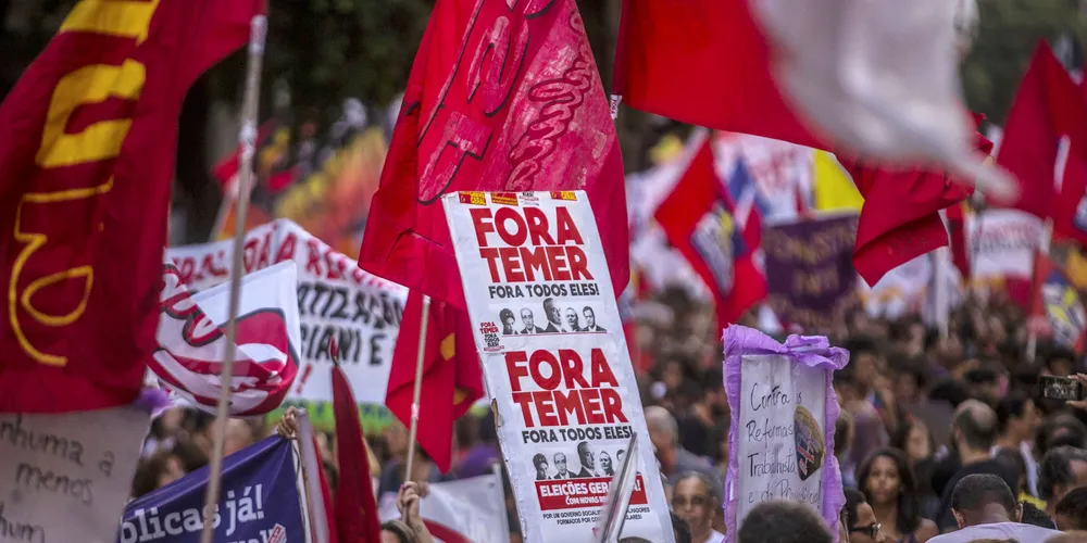 A demonstrator holds a banner reading "Out Temer" during a protest in Rio de Janeiro. Photo: Dado Galdieri/Bloomberg via Getty Images