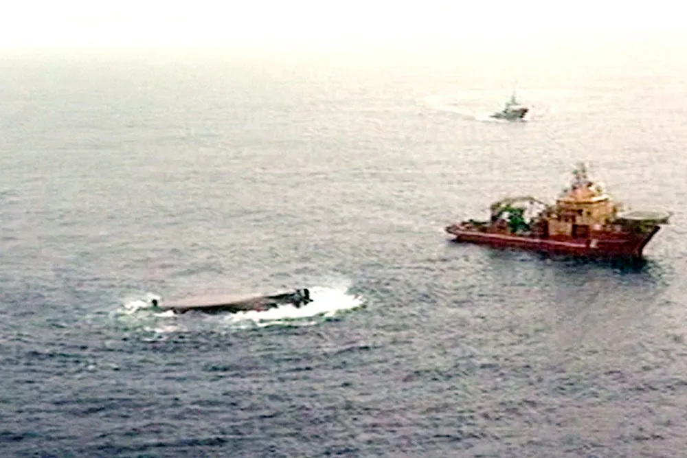 Tragedy: rescue vessels lie alongside the capsized Bourbon Dolphin
