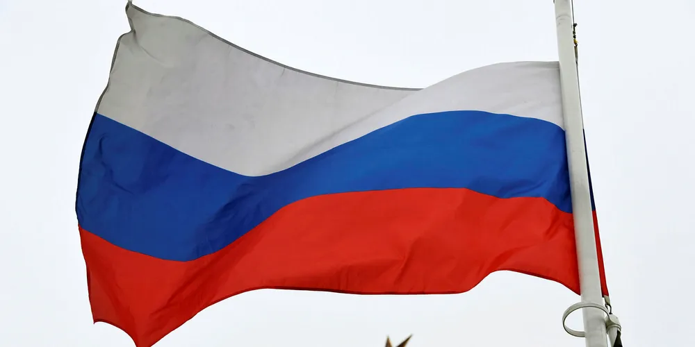 A Russian flag flies in front of a ruby star atop one of the Kremlin's towers in downtown Moscow on March 13, 2018.