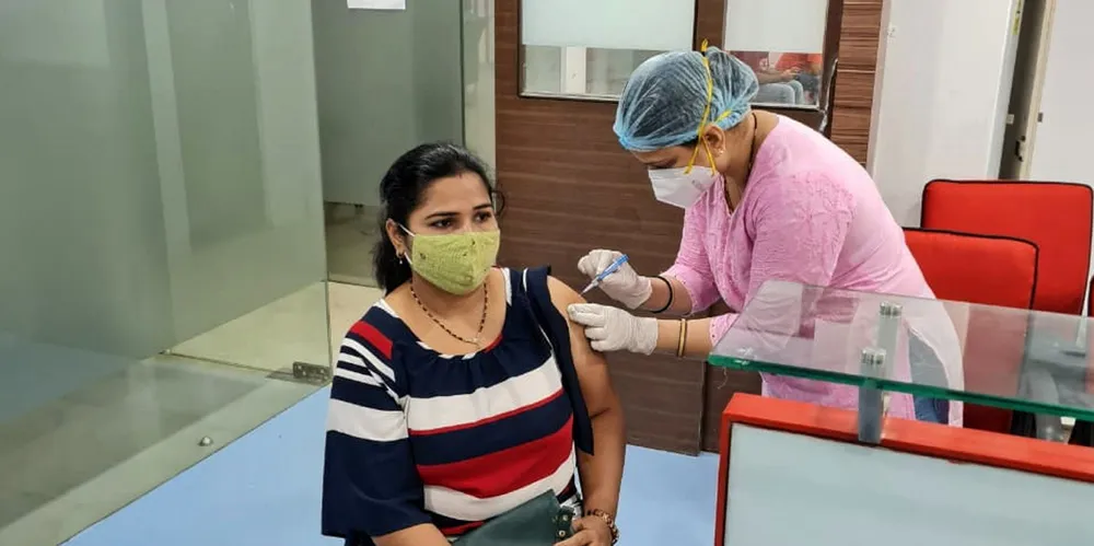 A woman gets vaccinated under the National Union of Seafarers of India vaccination scheme that provided jabs for seafarers and their families.