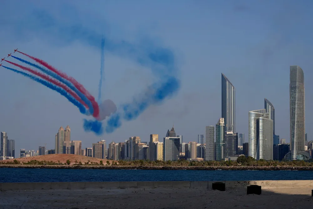 The UK's Royal Air Force Aerobatic Team, the Red Arrows, performs a display over the city skyline in Abu Dhabi, United Arab Emirates.