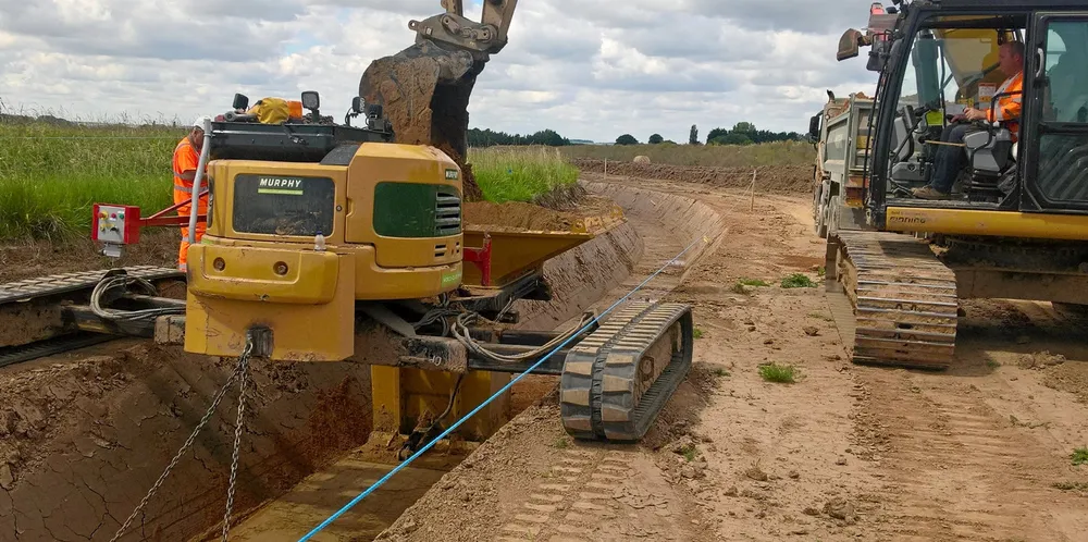 Excavating a trough for underground cable-laying