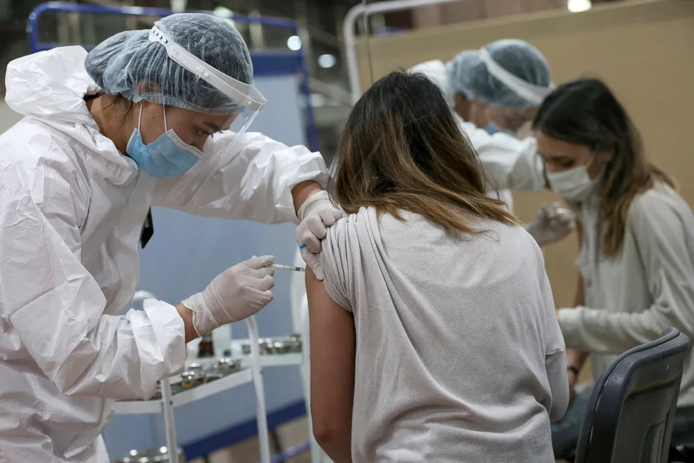 Slow recovery: a woman receives a shot of Russian-made Sputnik V vaccine against Covid-19 in the city of Almaty in Kazakhstan in April 2021