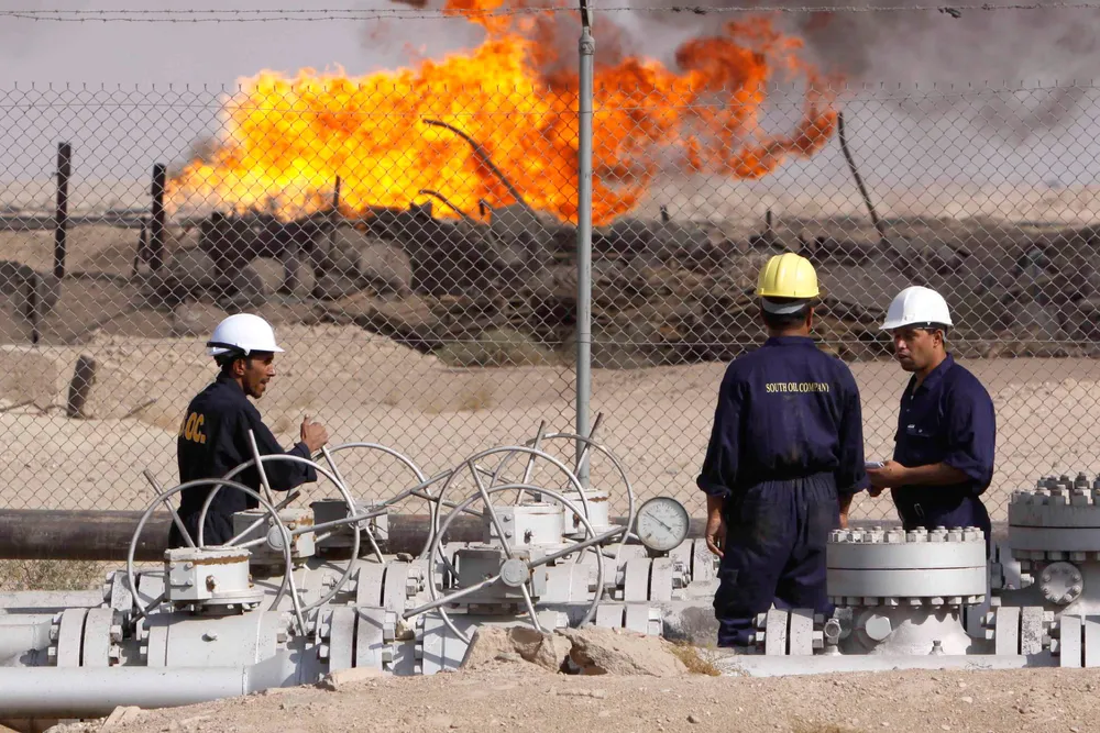 An Iraqi worker operates valves at the Rumaila oil refinery, near the city of Basra, 550 kilometres southeast of Baghdad, Iraq.