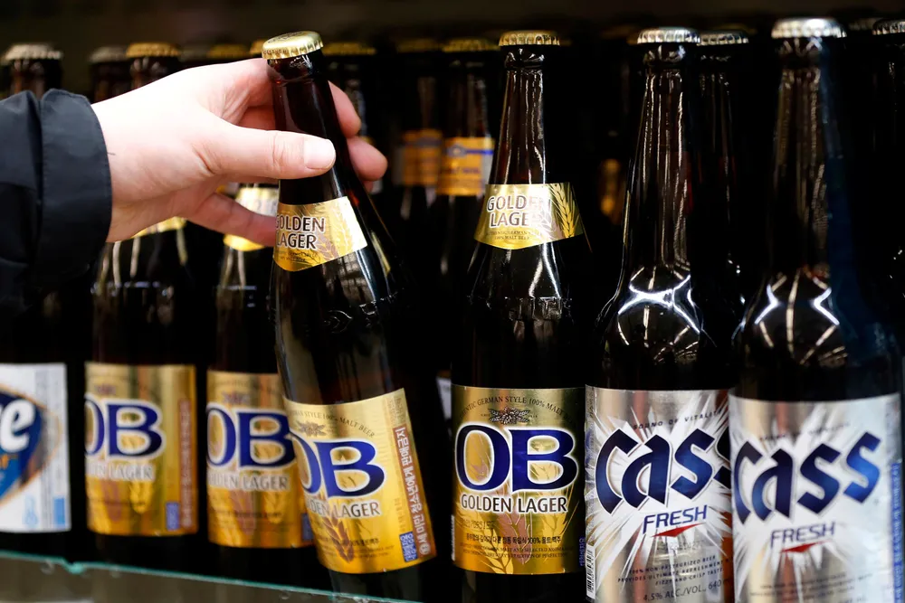 Choice: a man picks up a bottled beer produced by South Korea's Oriental Brewery at a supermarket in the capital Seoul