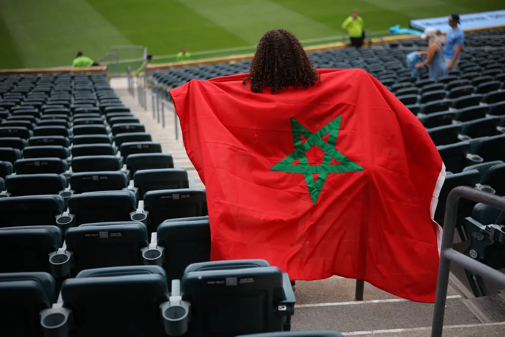 A football fan with a Morocco flag.