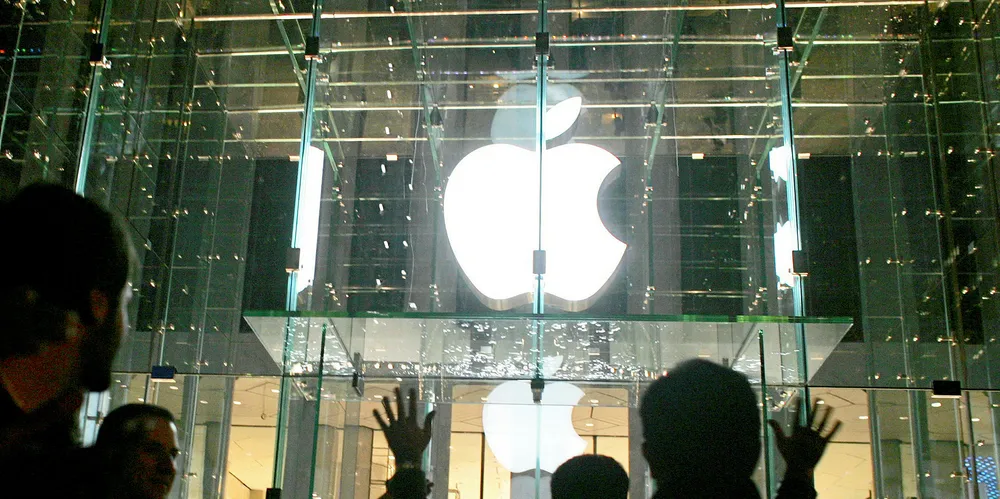 Visitors wait in line to enter the new Apple Store on Fifth Avenue in New York City.