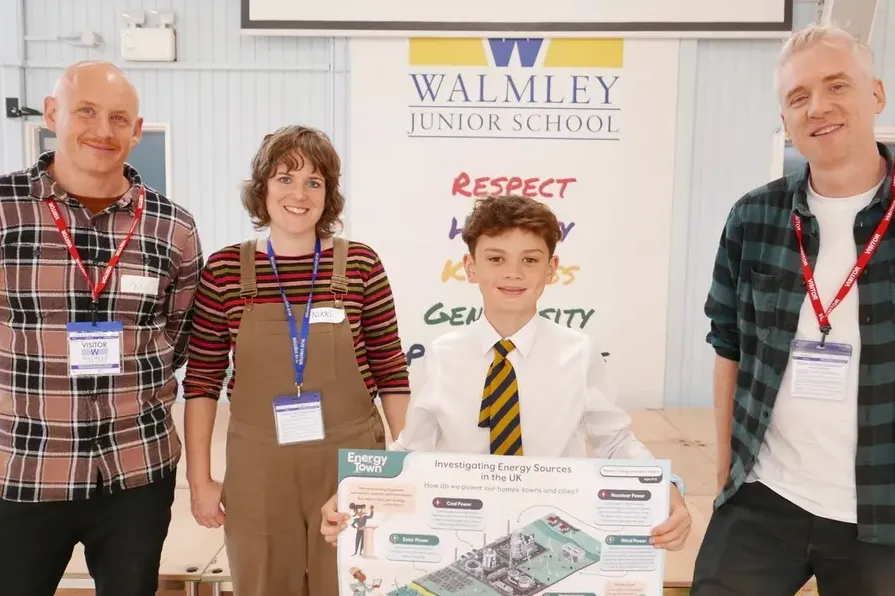 A winner of a primary school competition for the EnergyTown game is pictured with some of the Wonderverse learning resources.