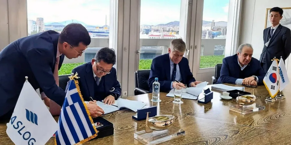 GasLog chief executive Paul Wogan (centre) and DSME vice president HG Park (left) sign contracts for four LNG newbuildings in December watched by GasLog chairman Peter Livanos (seated, far right).