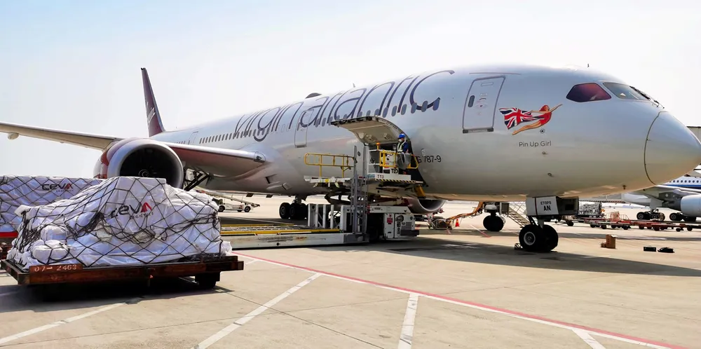 A Virgin Atlantic plane is loaded with cargo.