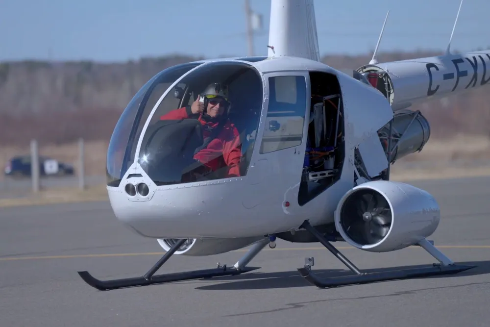 Helicopter pilot Ric Webb in the retrofitted R44 during the test flight