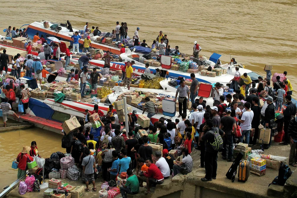Vessels: passengers wait for the express boats at a jetty on the south bank of the Rajang River in Kapit, Sarawak