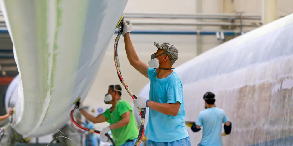 Mingyang employees work on a blade - the latest model is 140-metres long.