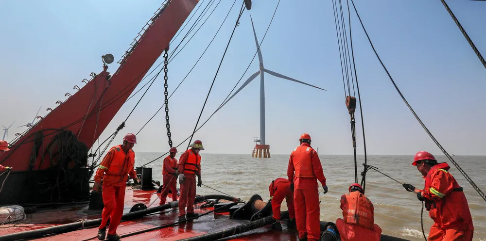 Employees of State Grid Corporation of China install a wind turbine in Zhoushan, Zhejiang Province of China.
