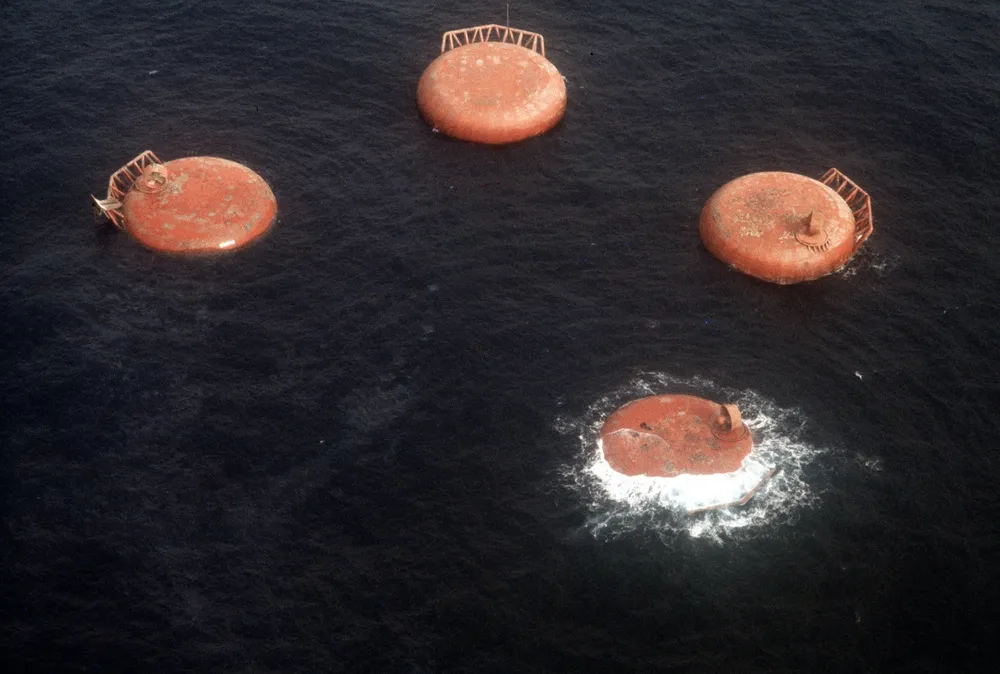 Aftermath: the morning after the capsize, the four legs of the Alexander Kielland are visible on the sea's surface