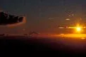 Bright prospect: the sun sets close to Mount Taranaki in New Zealand