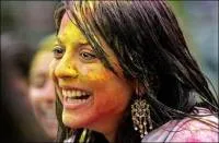 All smiles in India:A Hindu girl after coloured flower was thrown at her during a Shoba Yatra procession