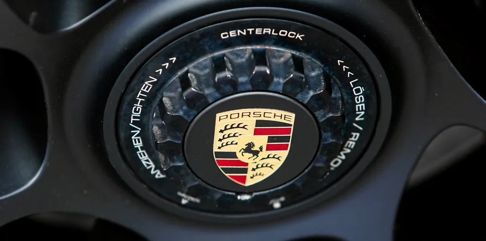 Porsche logo is seen on a car tyre.