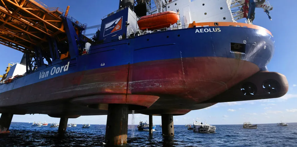 Fishing boats surround the drilling platform ship "Aeolus" in the Bay of Saint-Brieuc, western France to protest against the planned construction of 62 wind turbines offshore in the bay.