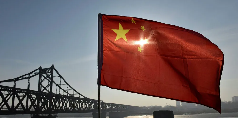 The Chinese flag flies on the Yalu River Broken Bridge.