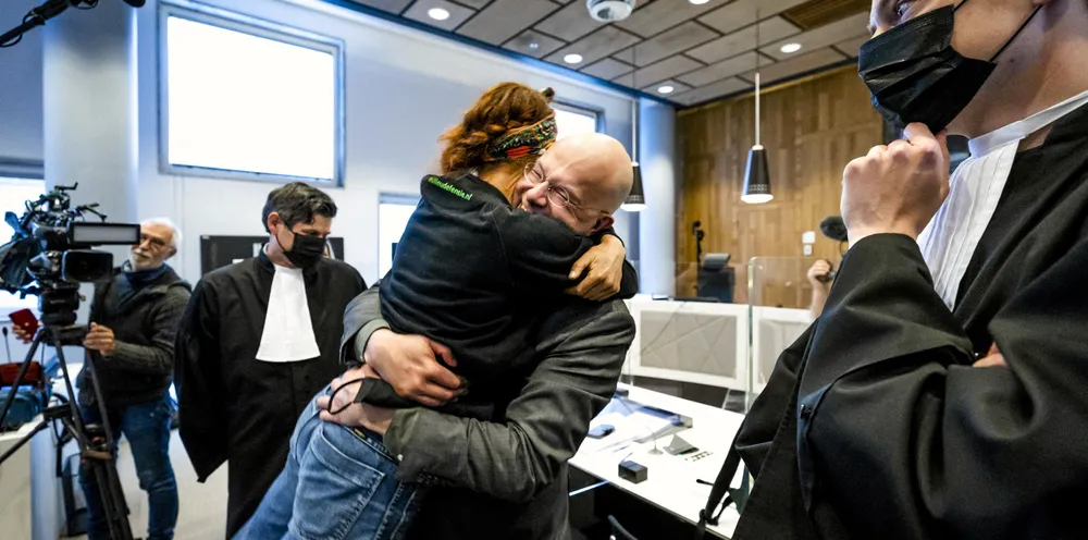 Director of Dutch environment organisation 'Milieudefensie' Donald Pols (C) celebrates outside a court in The Hague on May 26, 2021, after the district court ruled that Anglo-Dutch multi-national Shell must reduce its emissions by 45 percent by 2030.
