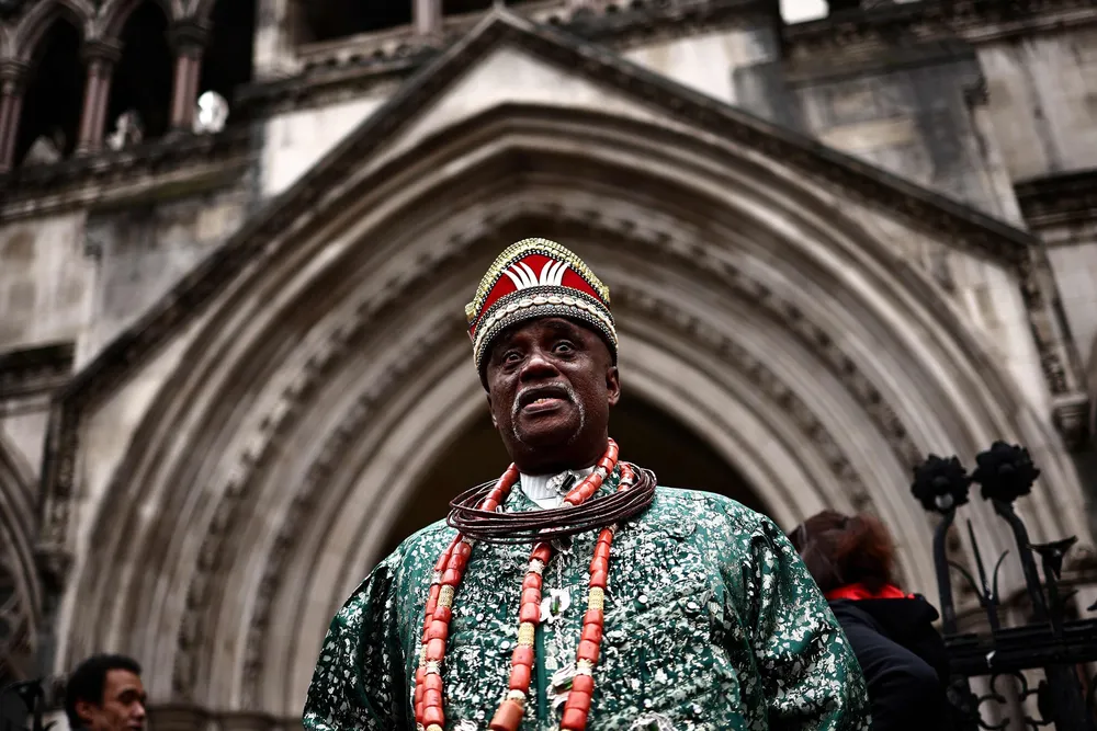 Nigerian tribal king Emere Godwin Bebe Okpabi stands outside the Royal Courts of Justice in London In February 2025 at the preliminary oil spill trial against Shell.