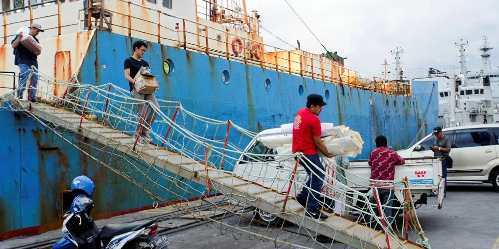 Indonesians offloading equipment from a fishing vessel. Thanks to the crackdown, there are 10,000 less boats plying the country's waters.