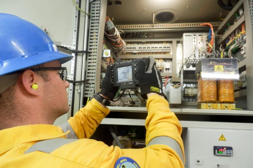 Close-up: Michael Guillory, electrician onboard the ultra-deepwater drillship Noble Don Taylor, uses the Onsight camera to help the RTTSC support staff troubleshoot a fault in an electrical cabinet