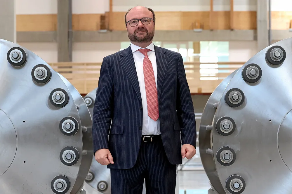 McPhy CEO Jean-Baptiste Lucas posing with electrolysers at the company's new gigafactory in Belfort, France.