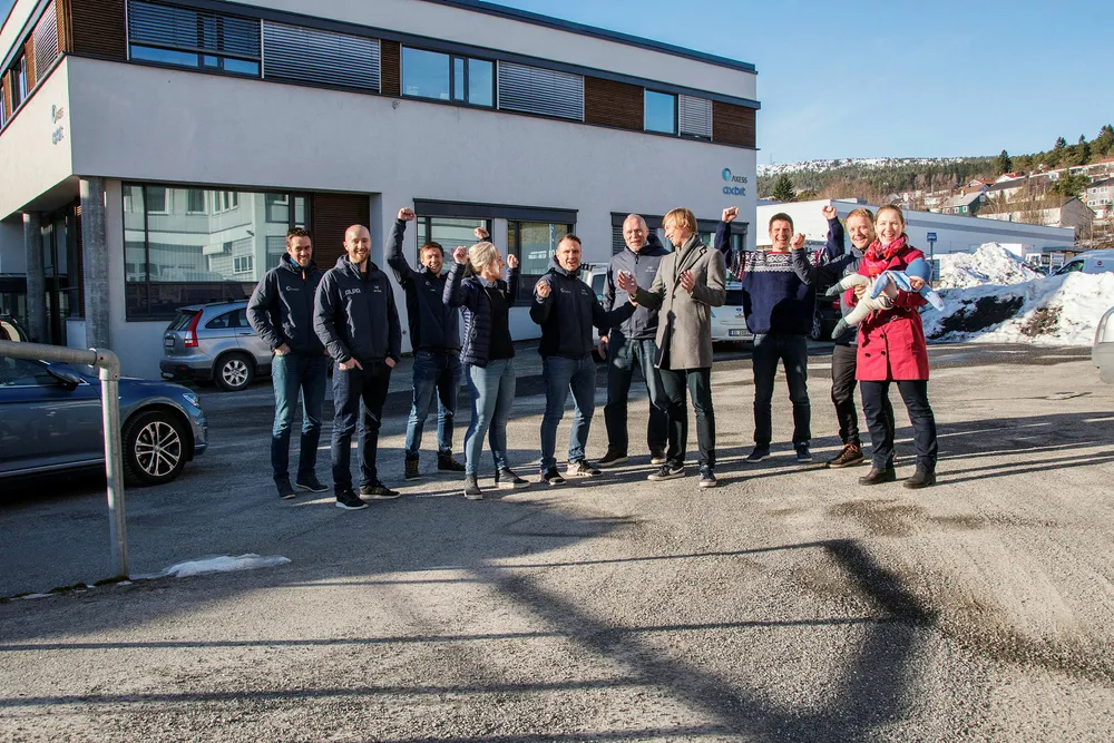 Ansatte ved Axess-hovedkontoret i Molde feirer den saftige 2017-bonusen. Fra venstre Øystein Nesse, Andreas Vegsund, Øystein Rasmussen, Lene Varhaugvik, Geir-Ove Bolli, Svein Eide, Knut Stefanussen, Leif Løken, Arne Litlere og Therese Monsås Langset med lillegutt Johannes Monsås Langset. Foto: Kjell Langmyren