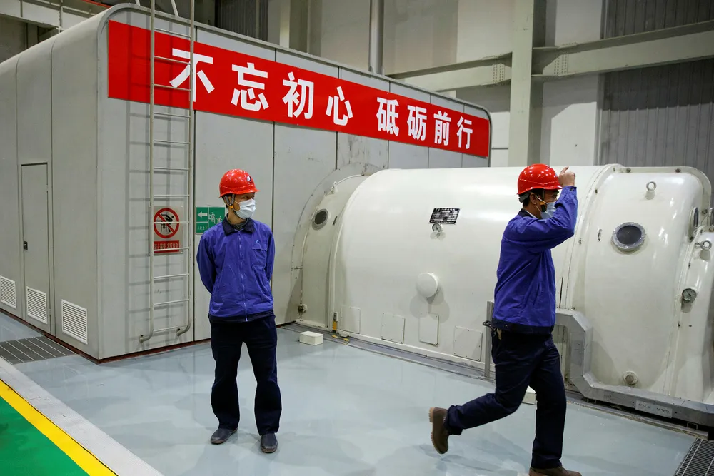 Caution: workers wear face masks during a government-organised tour of a Beijing power plant as the country is hit by a coronavirus outbreak