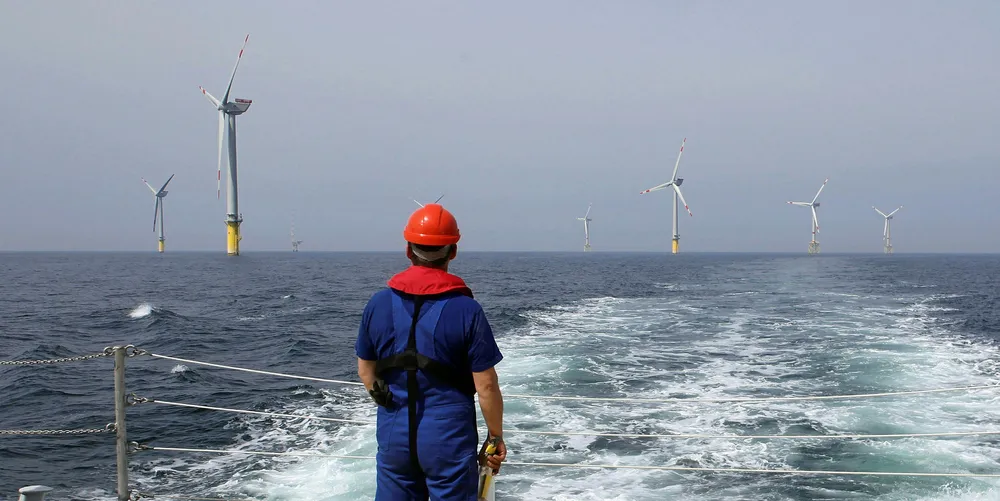 A worker looks out at wind turbines at the Alpha Ventus offshore wind farm in the North Sea.
