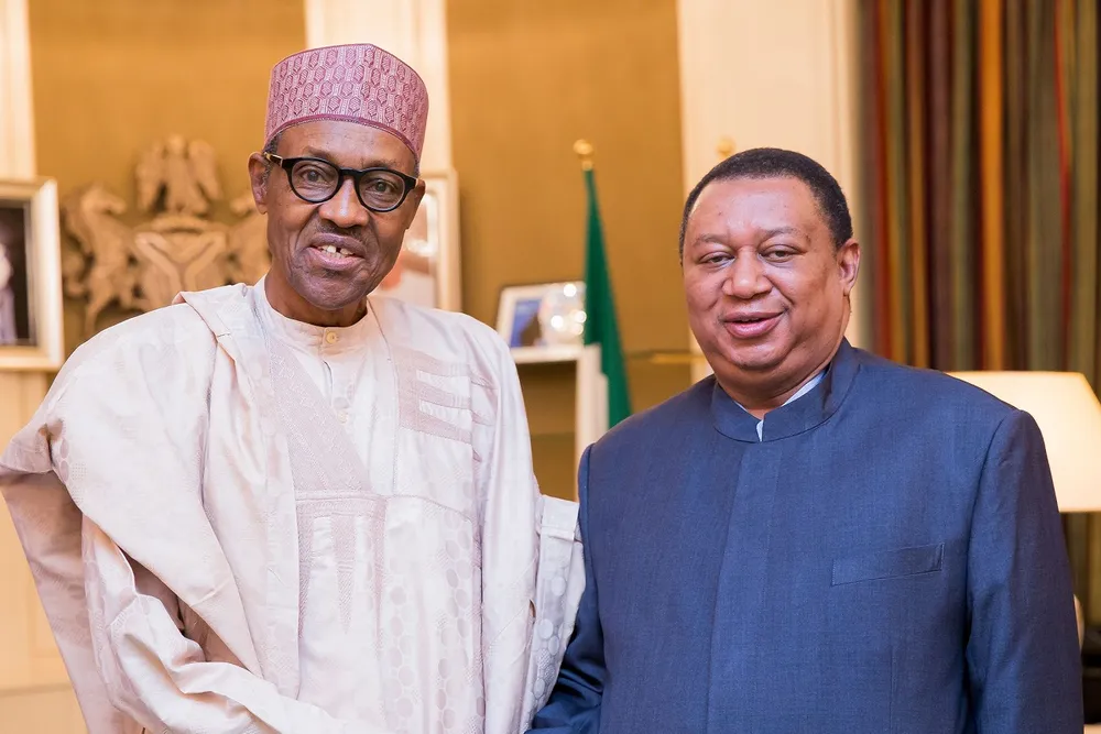 In Nigeria: Barkindo (R) shakes hand with President Mohammadu Buhari