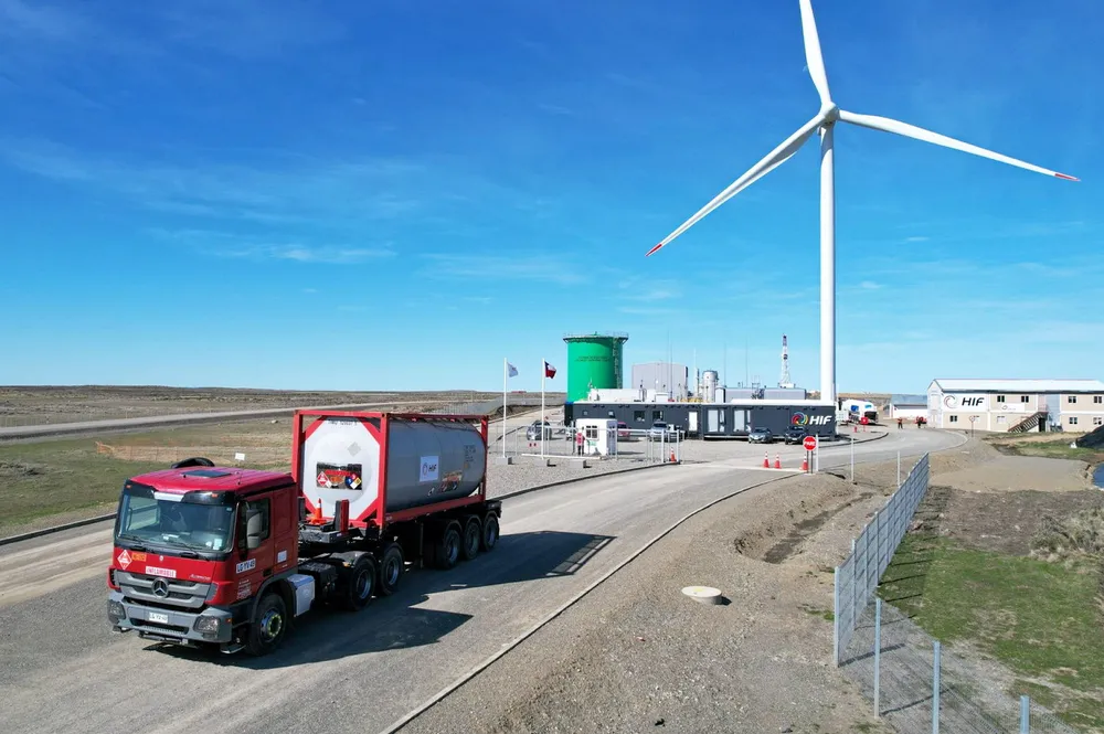 A truck transporting e-gasoline produced at HIF Global's Haru Oni facillity in southern Chile (pictured in background).