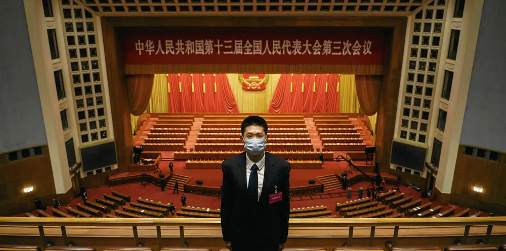 A Chinese security officer wears a protective mask as he guards after the closing session of the National People's Congress at the Great Hall of the People on May 28, 2020 in Beijing, China.