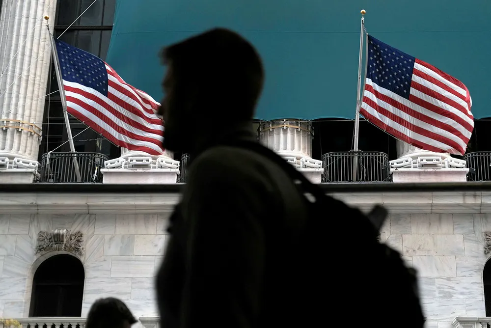 On the spot: people walk by the New York Stock Exchange this week