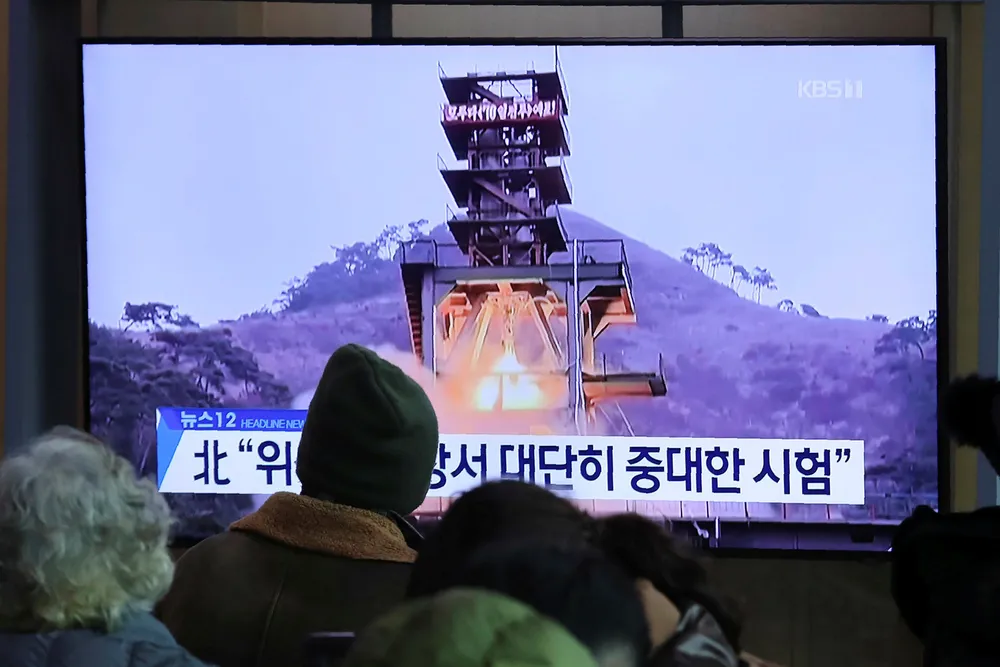 People watch a TV screen showing a file image of a ground test of North Korea's rocket engine during a news program at the Seoul Railway Station in Seoul, South Korea, Monday, Dec. 9, 2019. North Korea said Sunday it carried out a _very important test_ at its long-range rocket launch site that it reportedly rebuilt after having partially dismantled it after entering denuclearization talks with the United States last year. The sign reads: _Very important test._ (AP Photo/Ahn Young-joon)