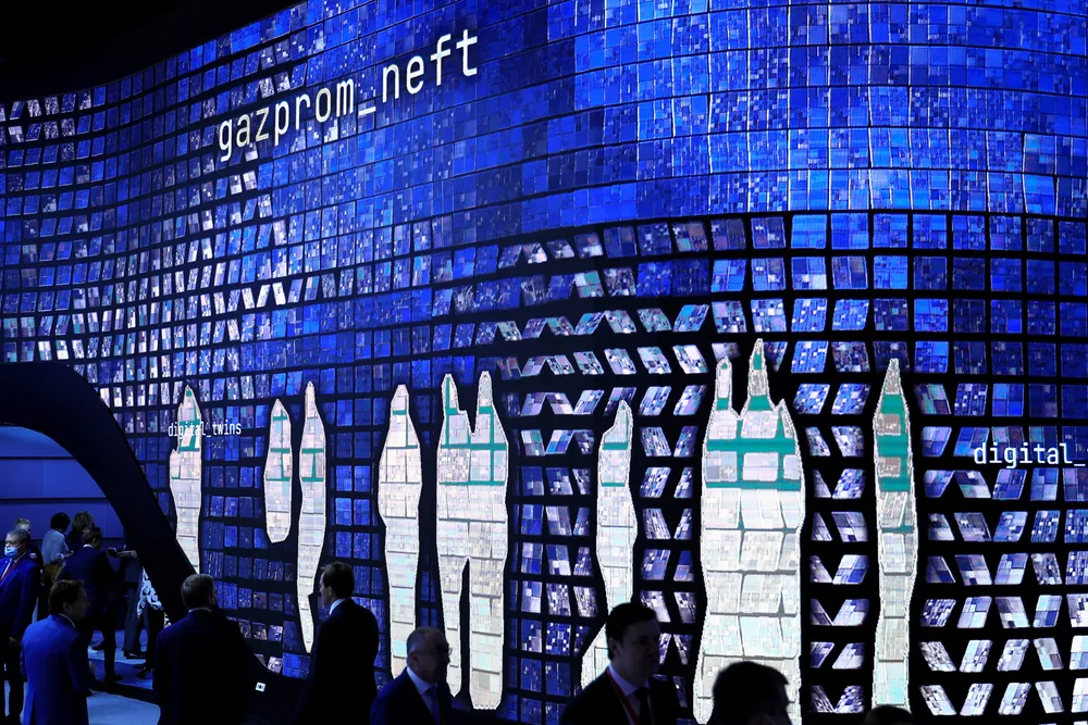 Blue trend: images of passing delegates at St Petersburg International Economic Forum in Russia are projected onto a Gazprom Neft stand