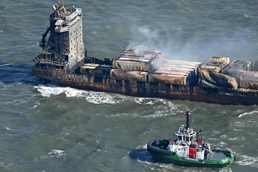 Smoke rises from damaged containers on the deck of the Solong, in the North Sea, on Tuesday after it collided with the tanker Stena Immaculate on Monday.